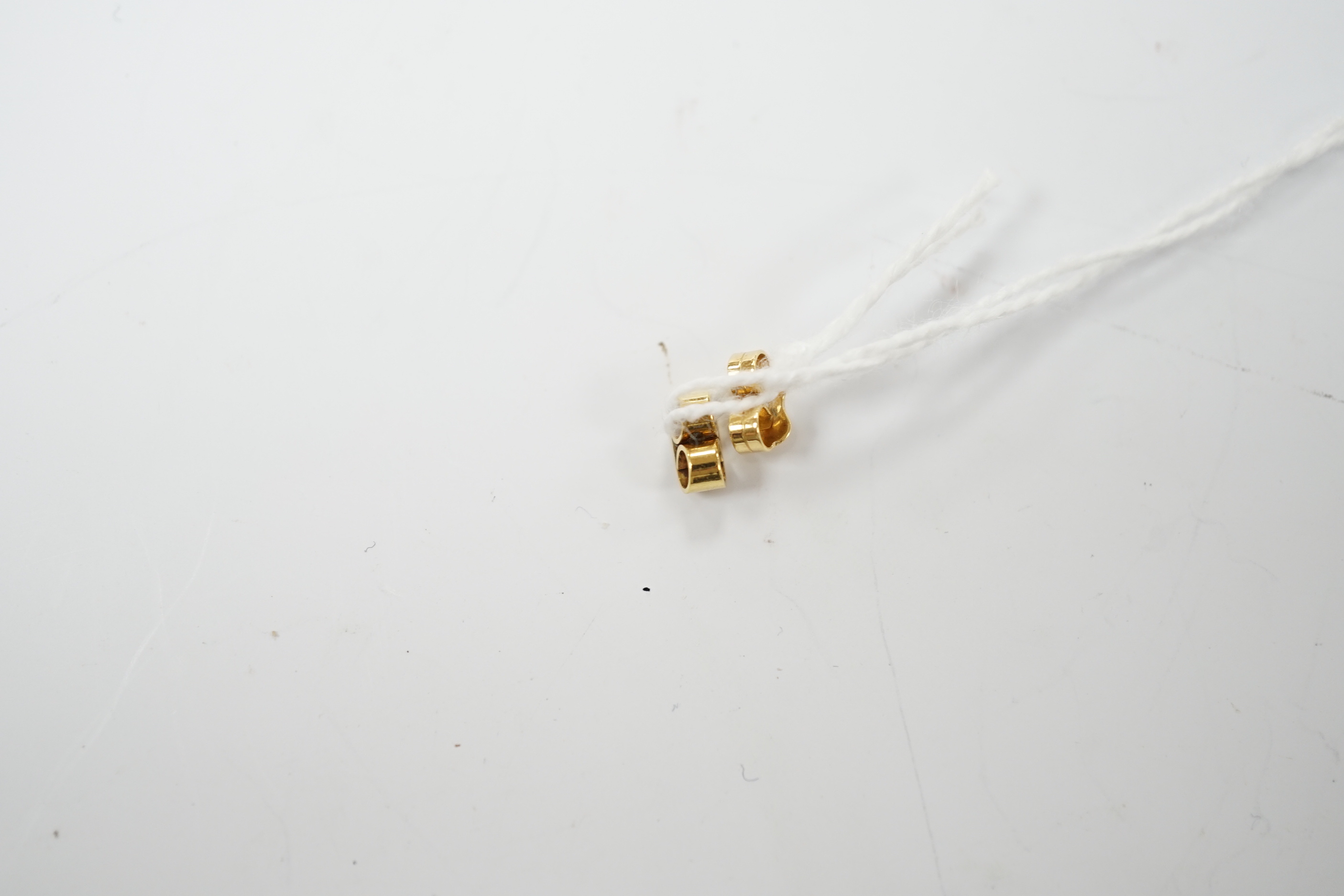 A modern pair of 18t gold, two emerald and sapphire set ear studs, 12mm by 7mm, gross weight 3.3 grams.